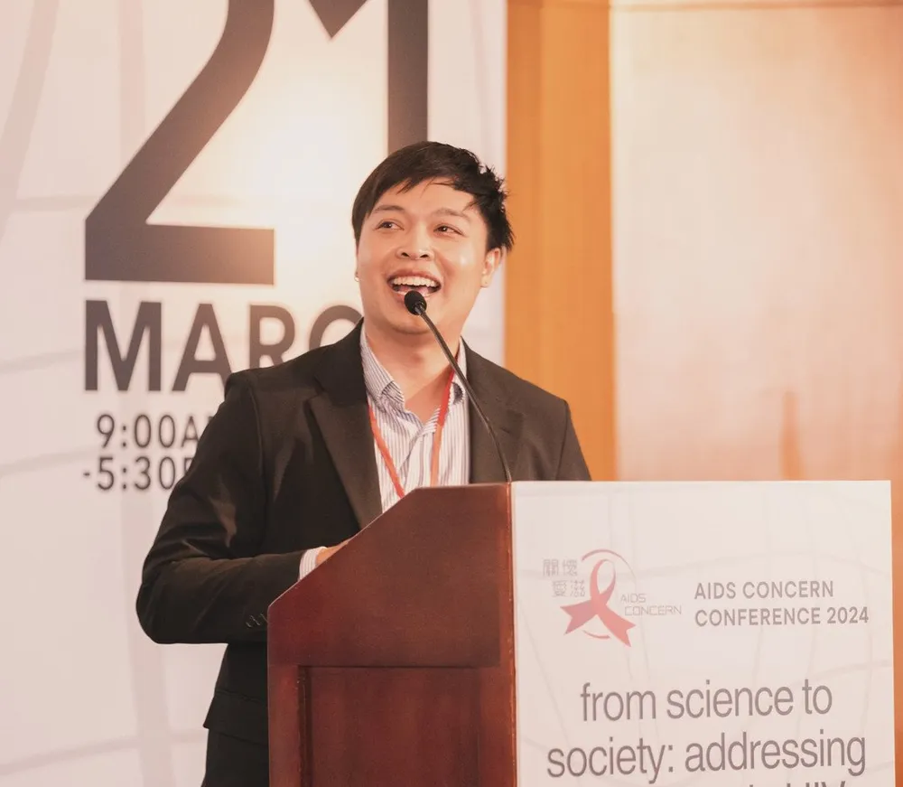 Arm speaking at a podium at the AIDS Concern Conference 2024 in Hong Kong